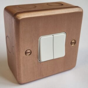 1-gang surface double switch with copper front for surface-mounted electrical conduit.